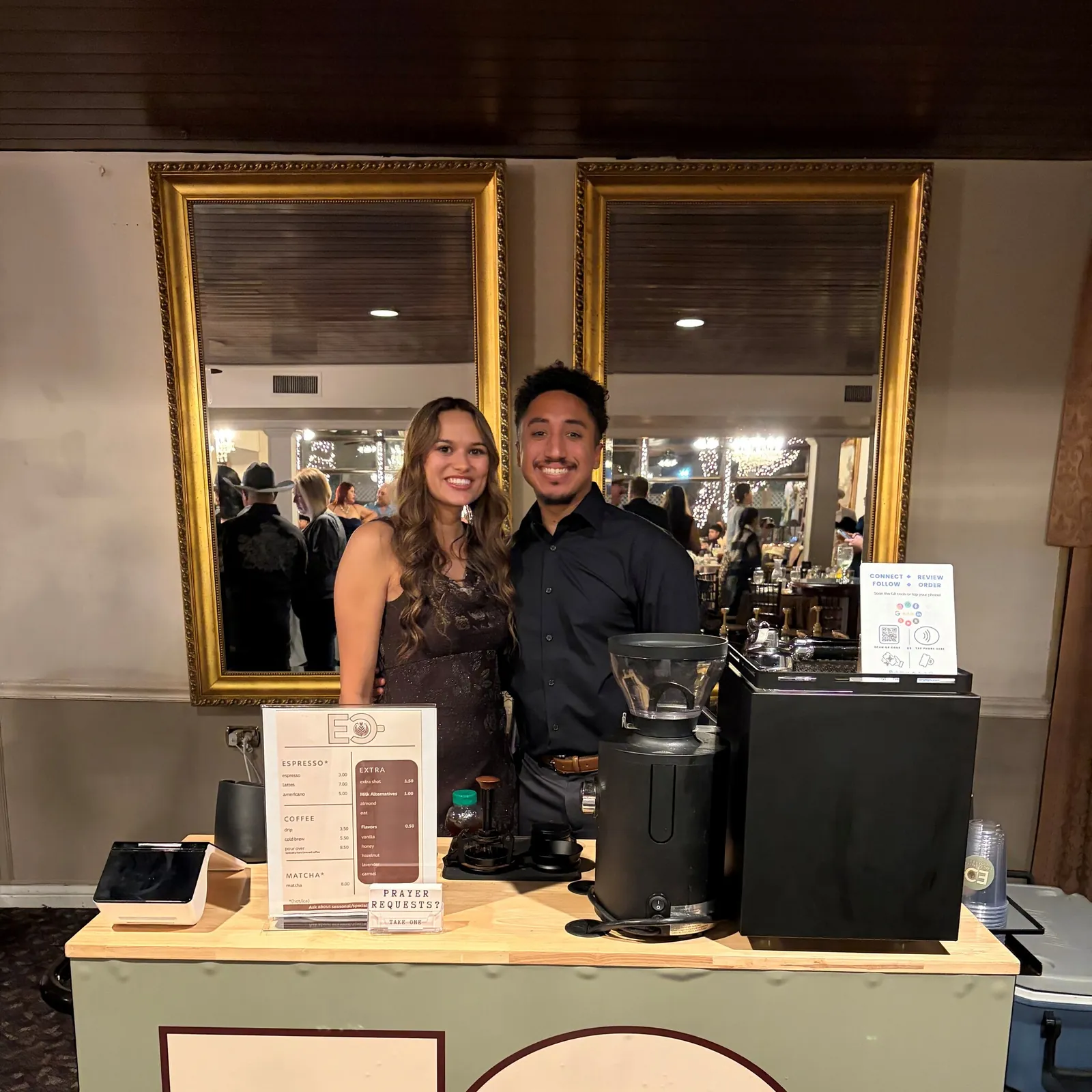 The Encounter Coffee cart set up indoors at a North Texas event venue with its printed espresso, coffee and matcha menu